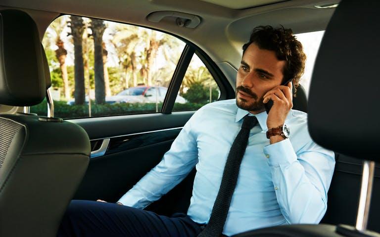 High End | longevity travel young man using chauffeur drive talking on 1 1
